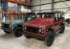 A Land Rover Defender 110 and Land Rover Defender 130 awaiting loading into a 40’ container by Autoshippers for shipping to the USA